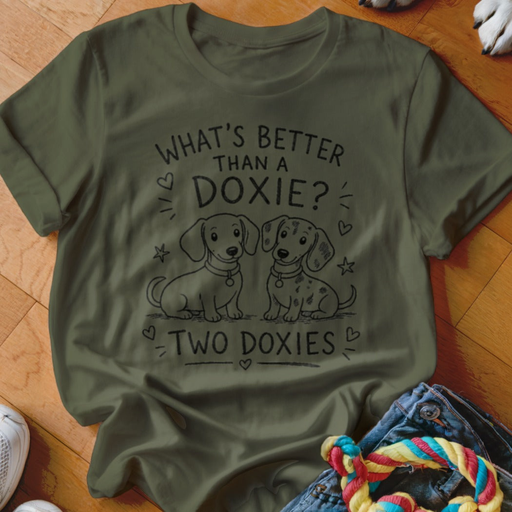 Olive green t-shirt with "What's Better Than a Doxie? Two Doxies" and cartoon dachshunds.