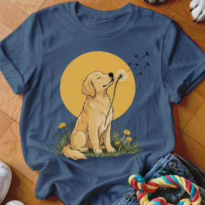 A blue crewneck t-shirt featuring a golden retriever blowing dandelion seeds against a yellow circle background.