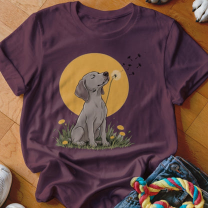 A dark purple t-shirt featuring a graphic of a grey dog blowing dandelion seeds.