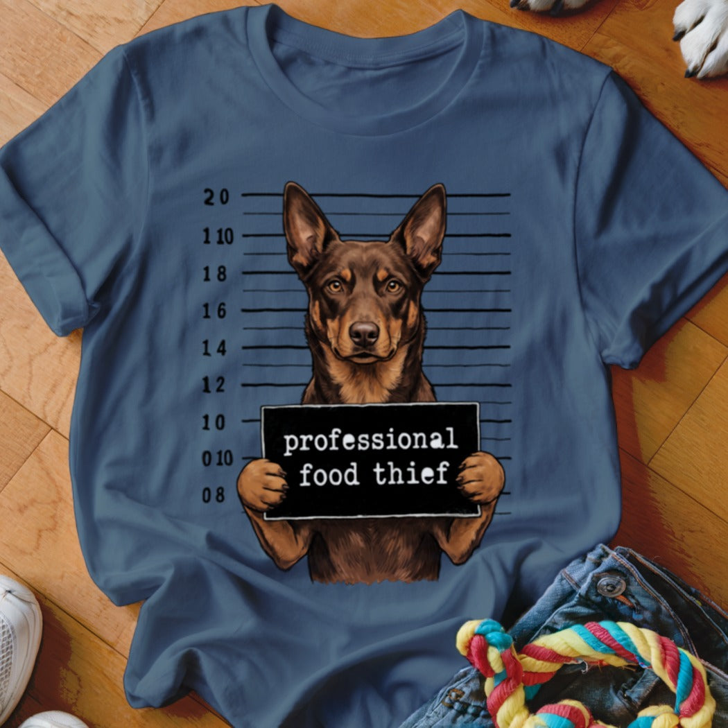 Brown dog with mugshot background holding a sign that says "professional food thief".