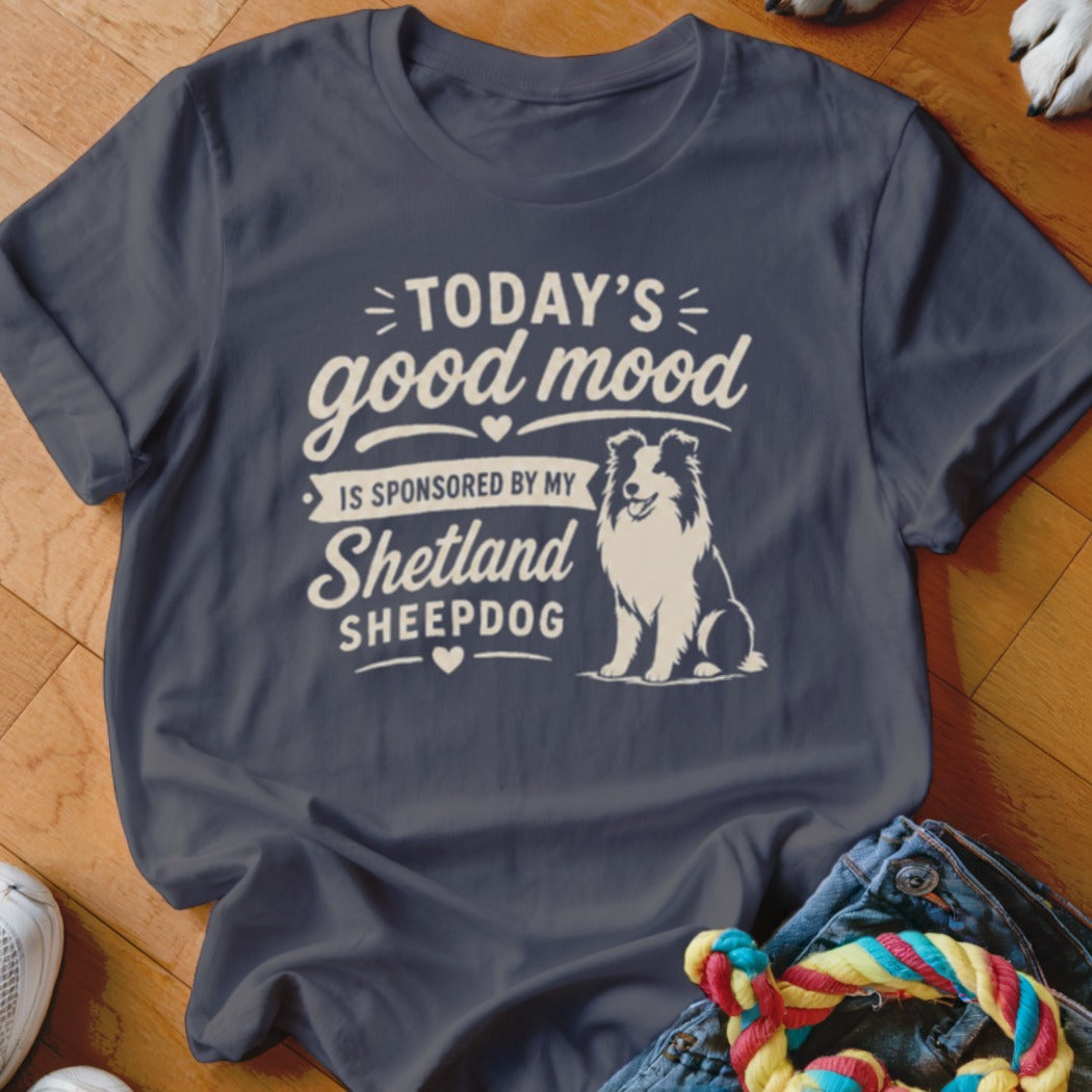 Dark blue t-shirt with white text "TODAY'S good mood IS SPONSORED BY MY Shetland SHEEPDOG" and a dog illustration.
