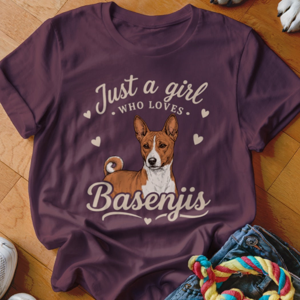 A maroon t-shirt featuring an illustration of a Basenji dog and the text Just a girl who loves Basenjis.