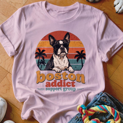 Light pink t-shirt featuring a Boston terrier graphic with sunglasses, palm trees, and the text Boston addict support group.