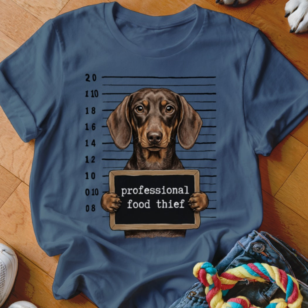 Dachshund mugshot with text "professional food thief" on t-shirt.