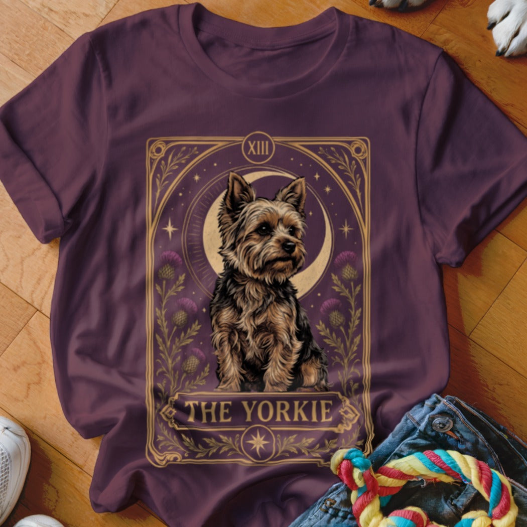 A dark plum t-shirt featuring a tarot card graphic of a Yorkshire terrier with the text THE YORKIE.