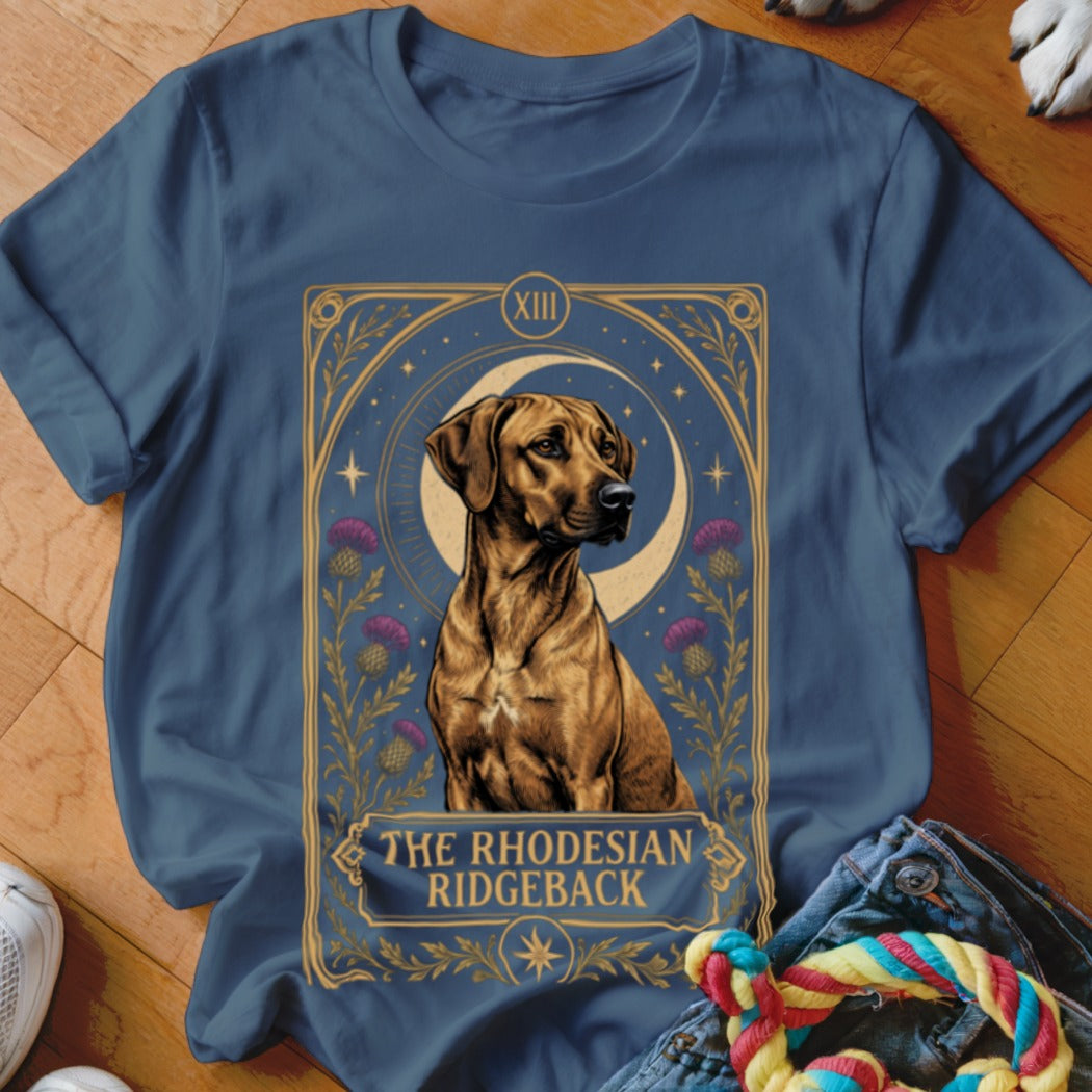 A dark blue t-shirt with a graphic of a Rhodesian Ridgeback framed like a tarot card.
