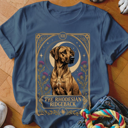 A dark blue t-shirt with a graphic of a Rhodesian Ridgeback framed like a tarot card.