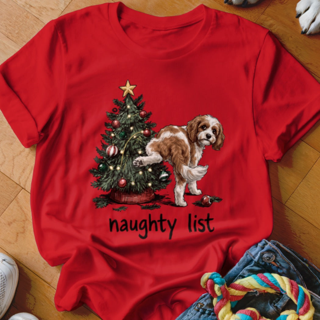 Red t-shirt with a dog peeing on a Christmas tree, text reads "naughty list".