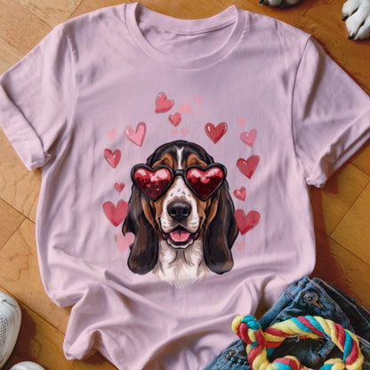 A light pink t-shirt featuring a basshound wearing heart-shaped sunglasses surrounded by floating pink hearts.