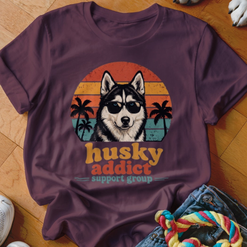 Maroon t-shirt featuring a retro graphic of a husky wearing sunglasses with palm trees and sunset stripes.