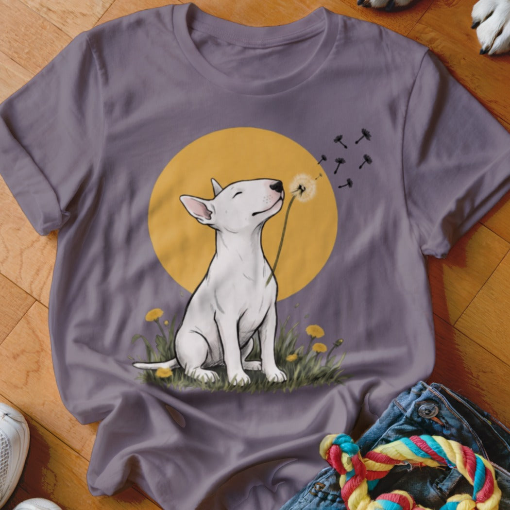 A purple crewneck t-shirt featuring an illustration of a white bull terrier blowing dandelion seeds.