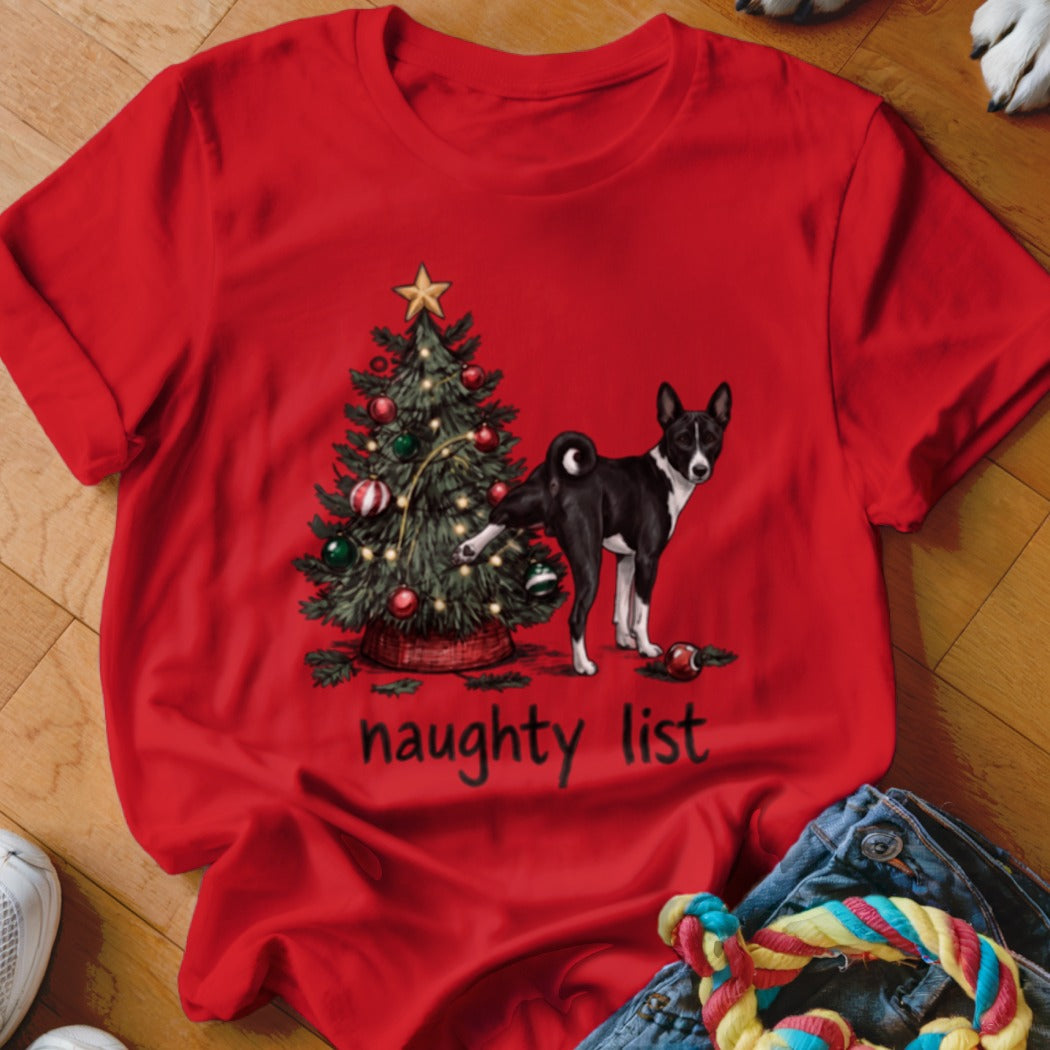 Red t-shirt featuring a graphic of a black and white dog lifting its leg on a Christmas tree, with the text "naughty list" below.