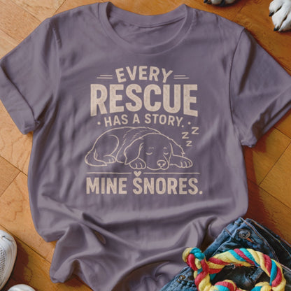Purple t-shirt with text "Every Rescue Has a Story. Mine Snores." and sleeping dog graphic.