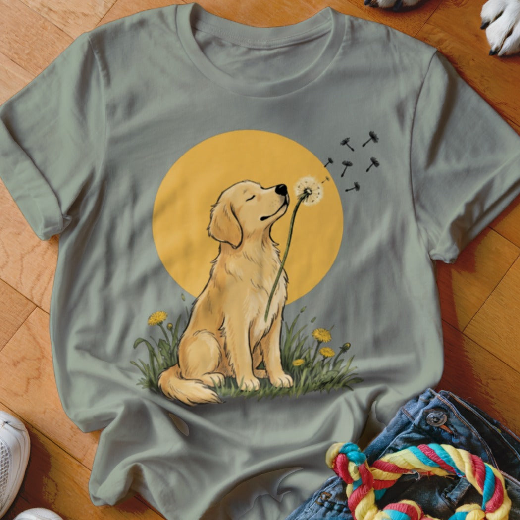 Sage green t-shirt featuring an illustration of a golden retriever holding a dandelion against a yellow circle.