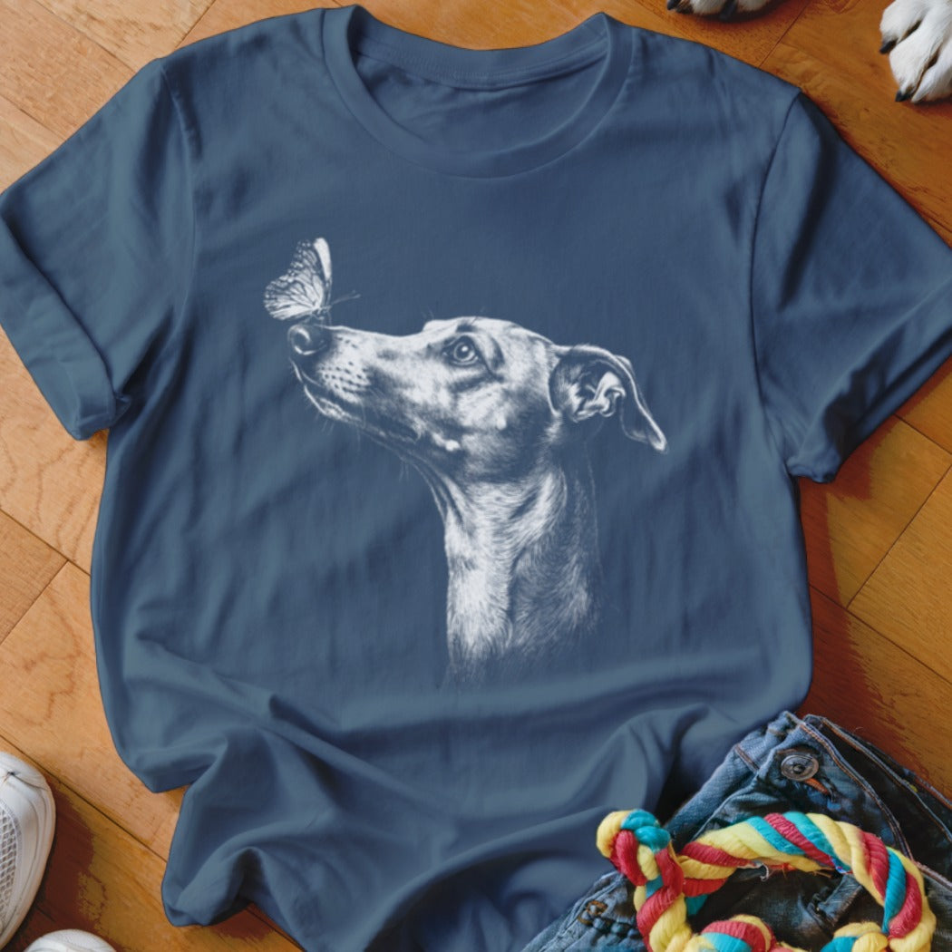 Blue t-shirt featuring a white sketch of a dog looking at a butterfly on its nose.