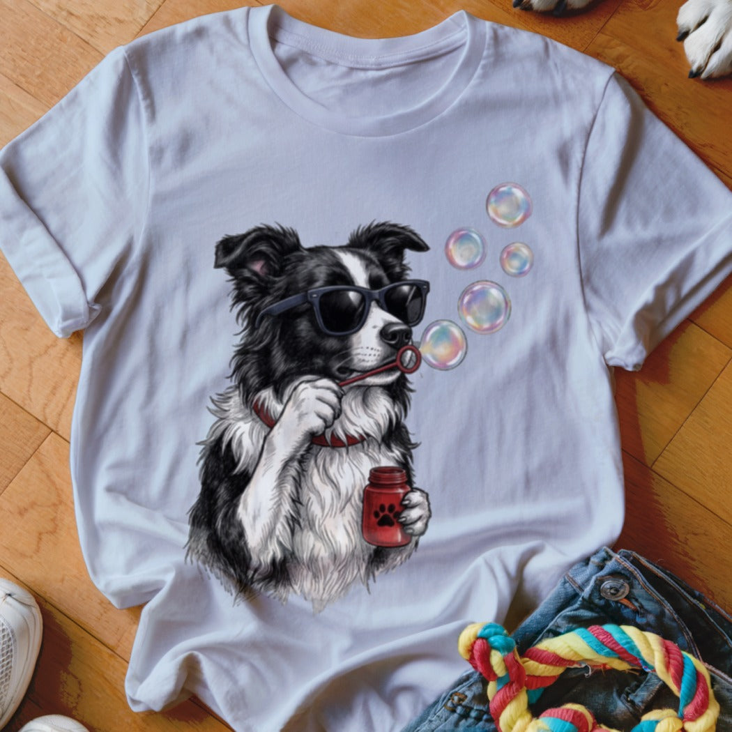A white crewneck t-shirt featuring an illustration of a black and white dog blowing bubbles.
