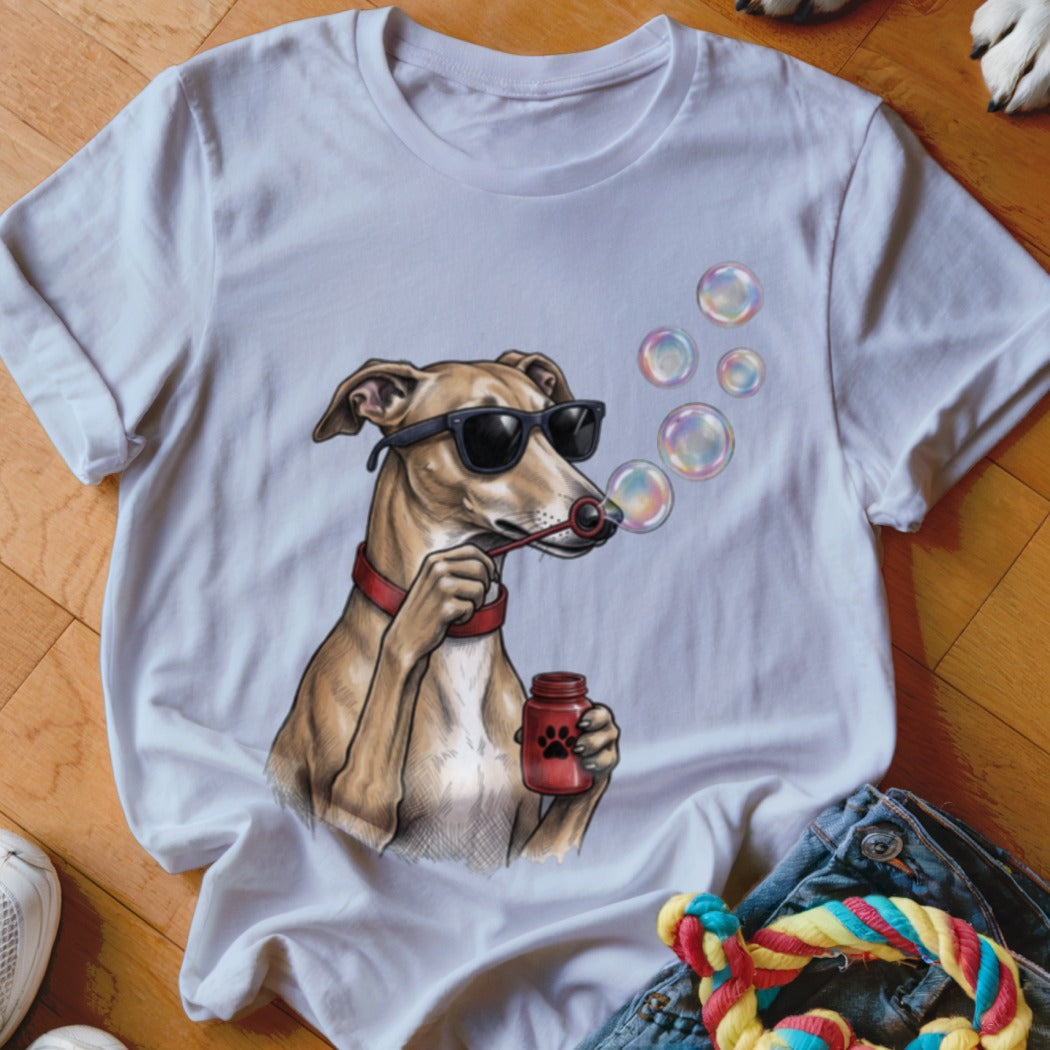 A white t-shirt featuring an illustration of a dog wearing sunglasses and blowing soap bubbles.