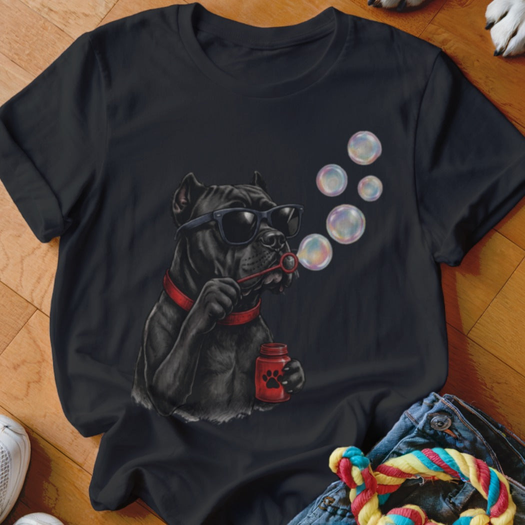 Black t-shirt featuring a graphic of a black dog wearing sunglasses while blowing soap bubbles.