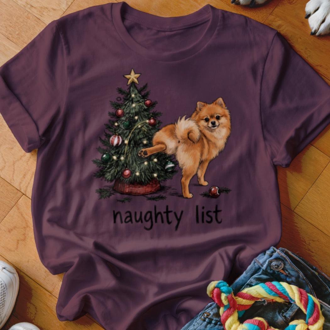 Pomeranian dog near Christmas tree with text "naughty list".