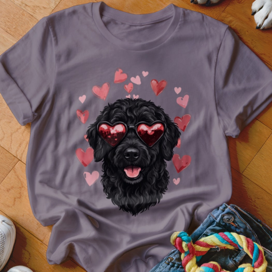 A dark gray t-shirt featuring a graphic of a black poodle wearing heart-shaped sunglasses surrounded by pink hearts.