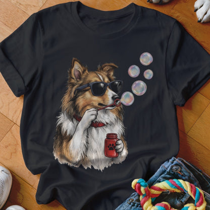 Black t-shirt featuring an illustration of a brown and white dog wearing sunglasses and blowing bubbles.
