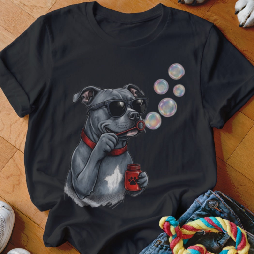 A black t-shirt features a graphic of a grey dog wearing sunglasses and blowing bubbles.