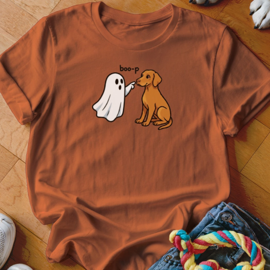 Cartoon ghost saying "boo-p" while booping a sitting dog's nose.