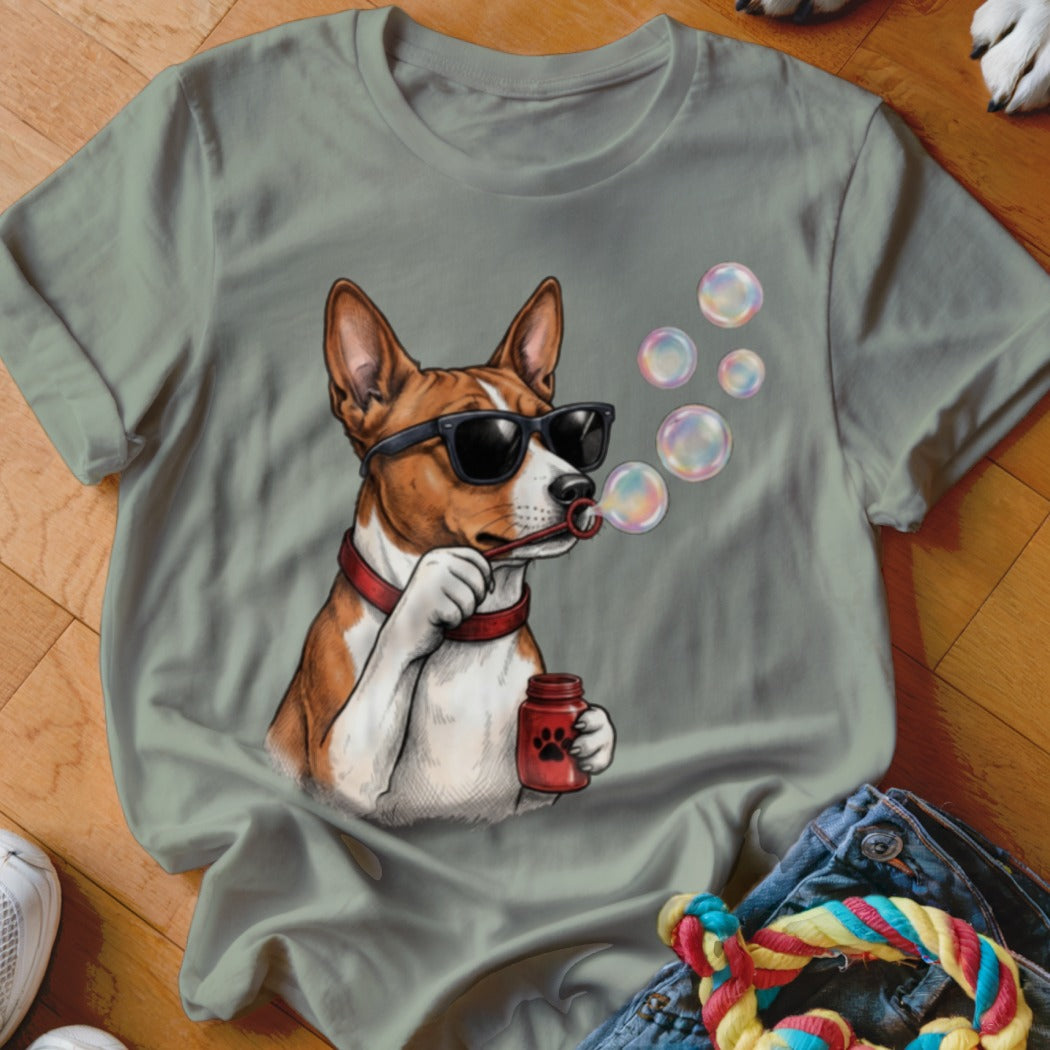 Sage green t-shirt featuring a graphic of a dog wearing sunglasses and blowing soap bubbles.