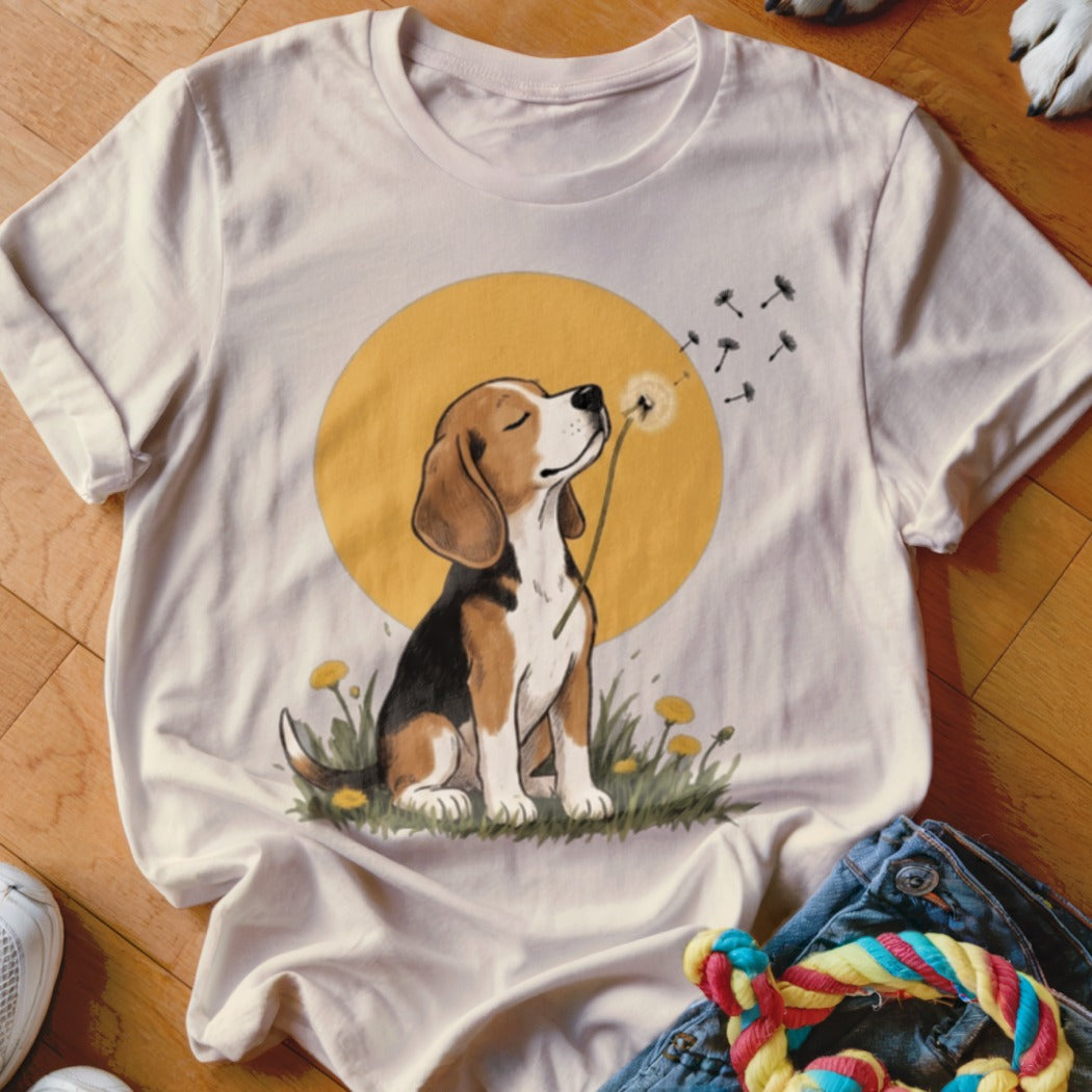 Beige crewneck t-shirt featuring an illustrated beagle blowing dandelion seeds against a yellow circle background.