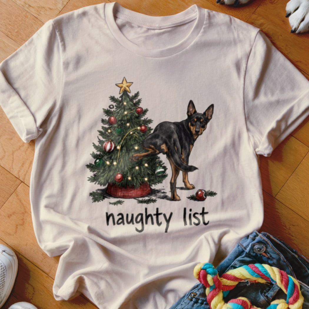 T-shirt with a dog near a Christmas tree, text reads "naughty list."