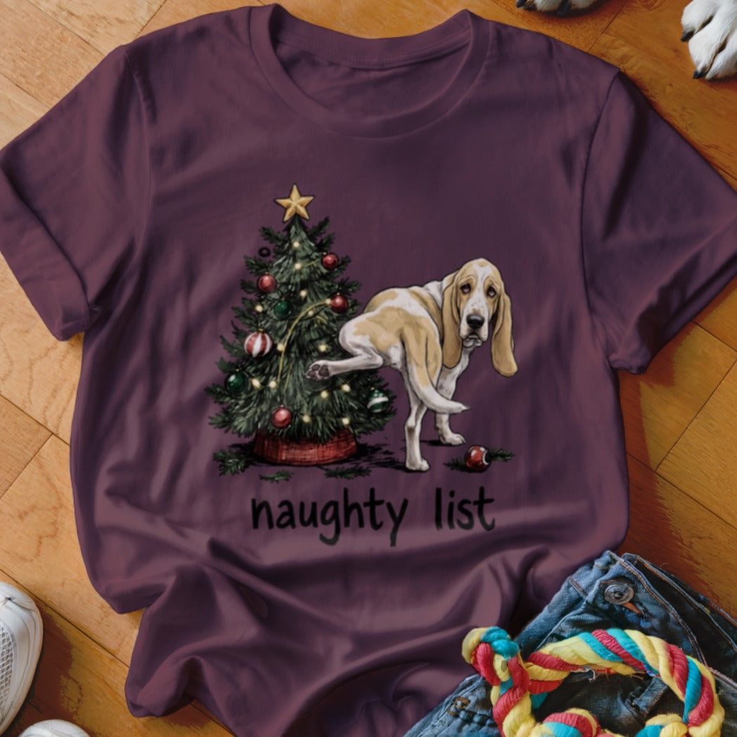 Basset Hound next to Christmas tree with text "naughty list".