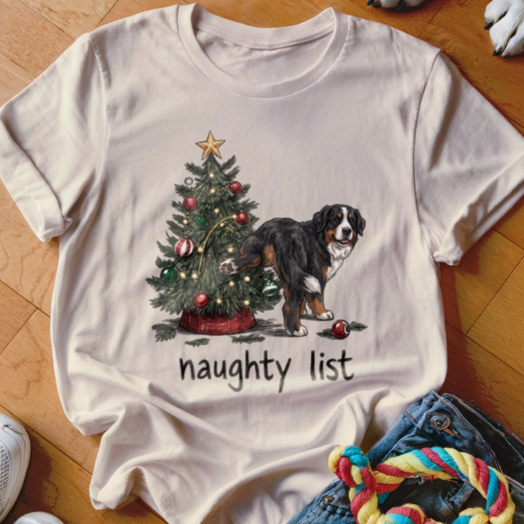 Bernese Mountain Dog lifting leg on Christmas tree, "naughty list" text.