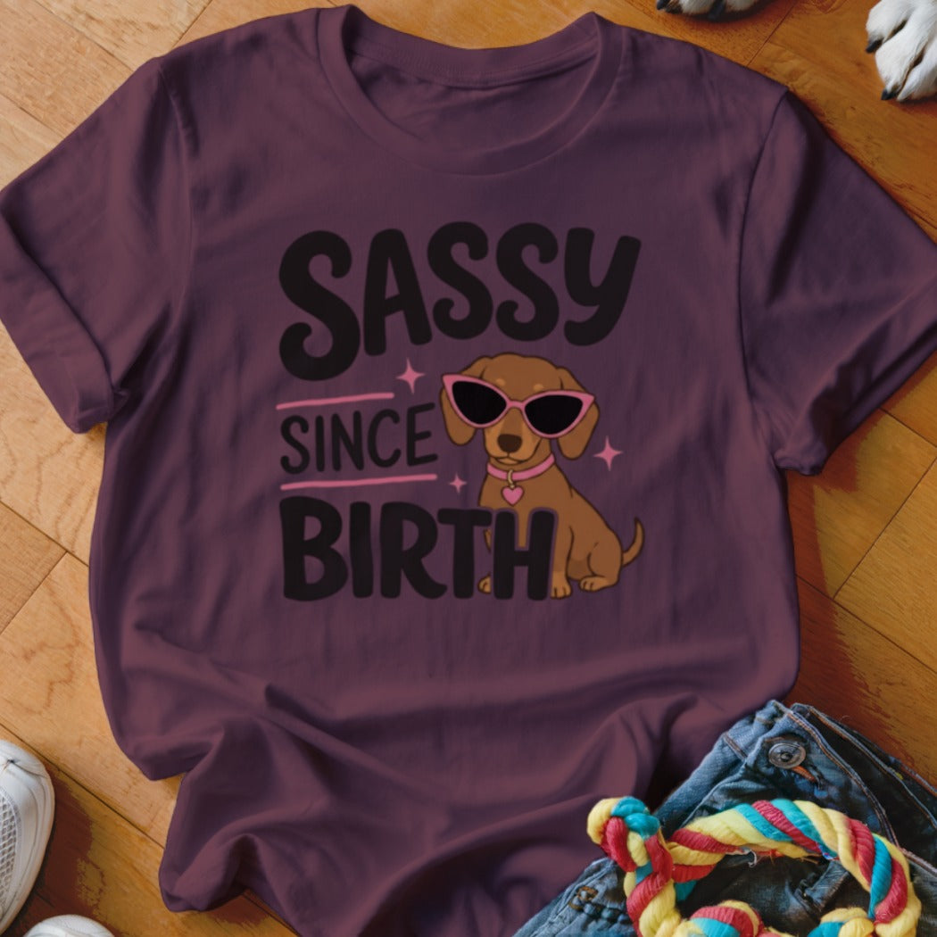 T-shirt with "Sassy Since Birth" text and cartoon dachshund wearing sunglasses.