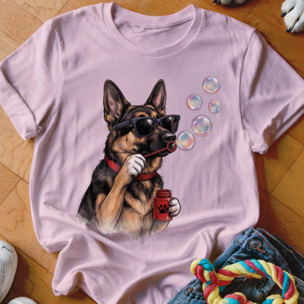 Light pink t-shirt featuring a graphic of a German Shepherd wearing sunglasses and blowing bubbles.