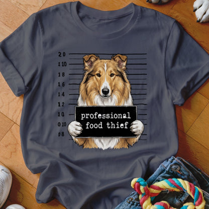 Collie dog mugshot with sign reading "professional food thief."