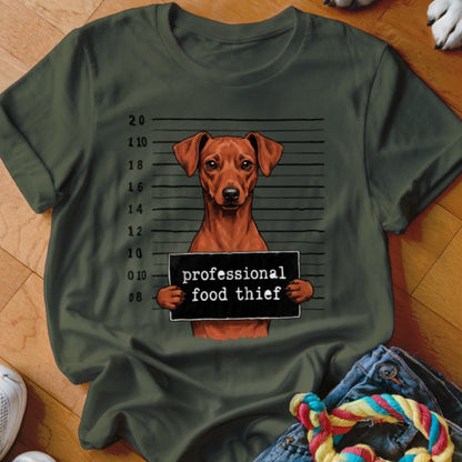 Brown dog mugshot with sign reading "professional food thief".