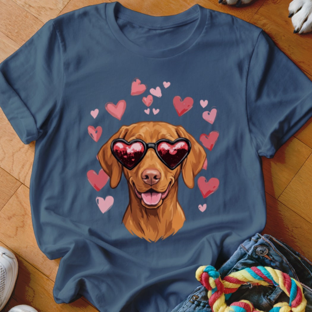 A slate blue t-shirt printed with a brown dog wearing heart-shaped sunglasses surrounded by pink hearts.