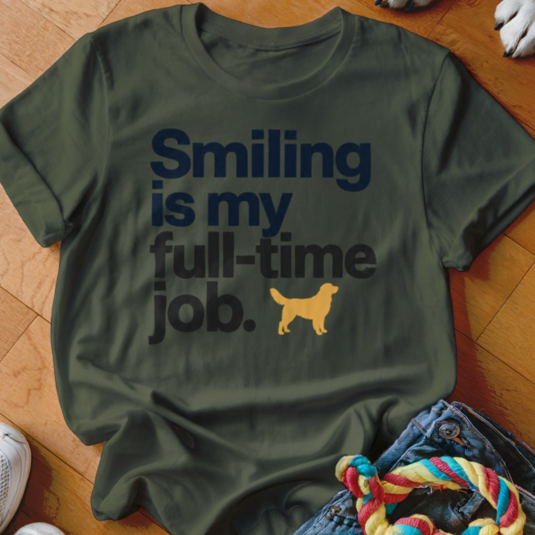 Dark green t-shirt with the navy text "Smiling is my full-time job" and a small yellow dog silhouette.