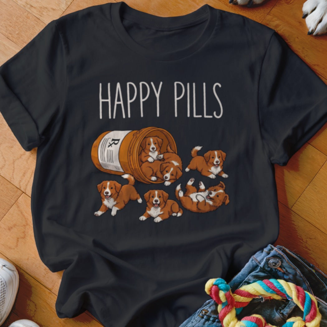 Dark t-shirt with "HAPPY PILLS" text and cartoon puppies spilling from a pill bottle.