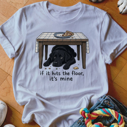 White t-shirt graphic: black lab under a table with pizza. "If it hits the floor, it's mine."