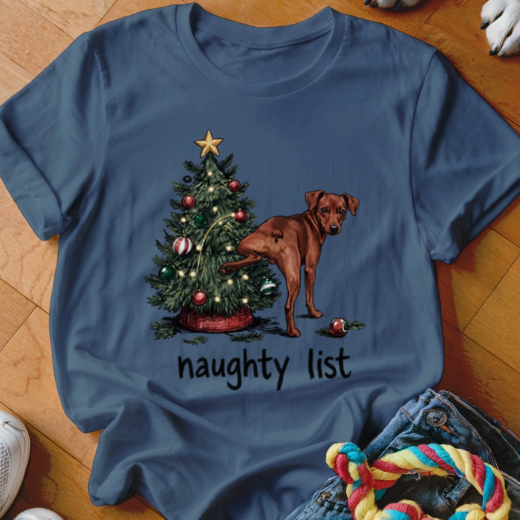Brown dog near a Christmas tree with lights, text reads "naughty list".