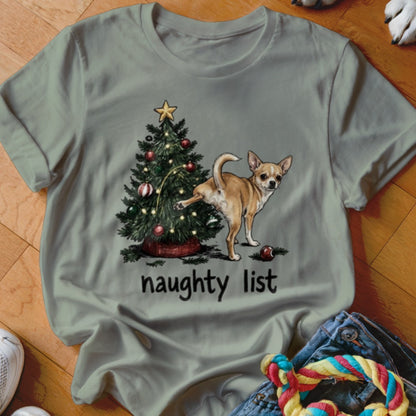 Chihuahua next to Christmas tree with text "naughty list"