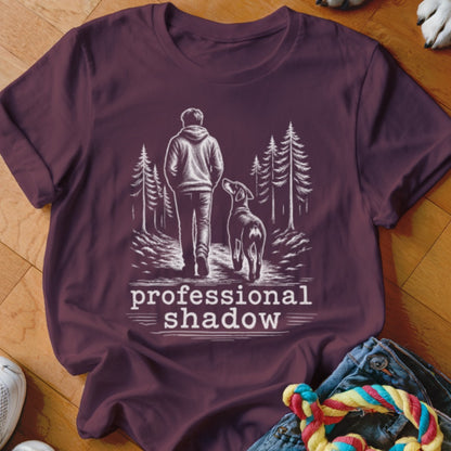 Line art of person and dog walking in woods with text "professional shadow".