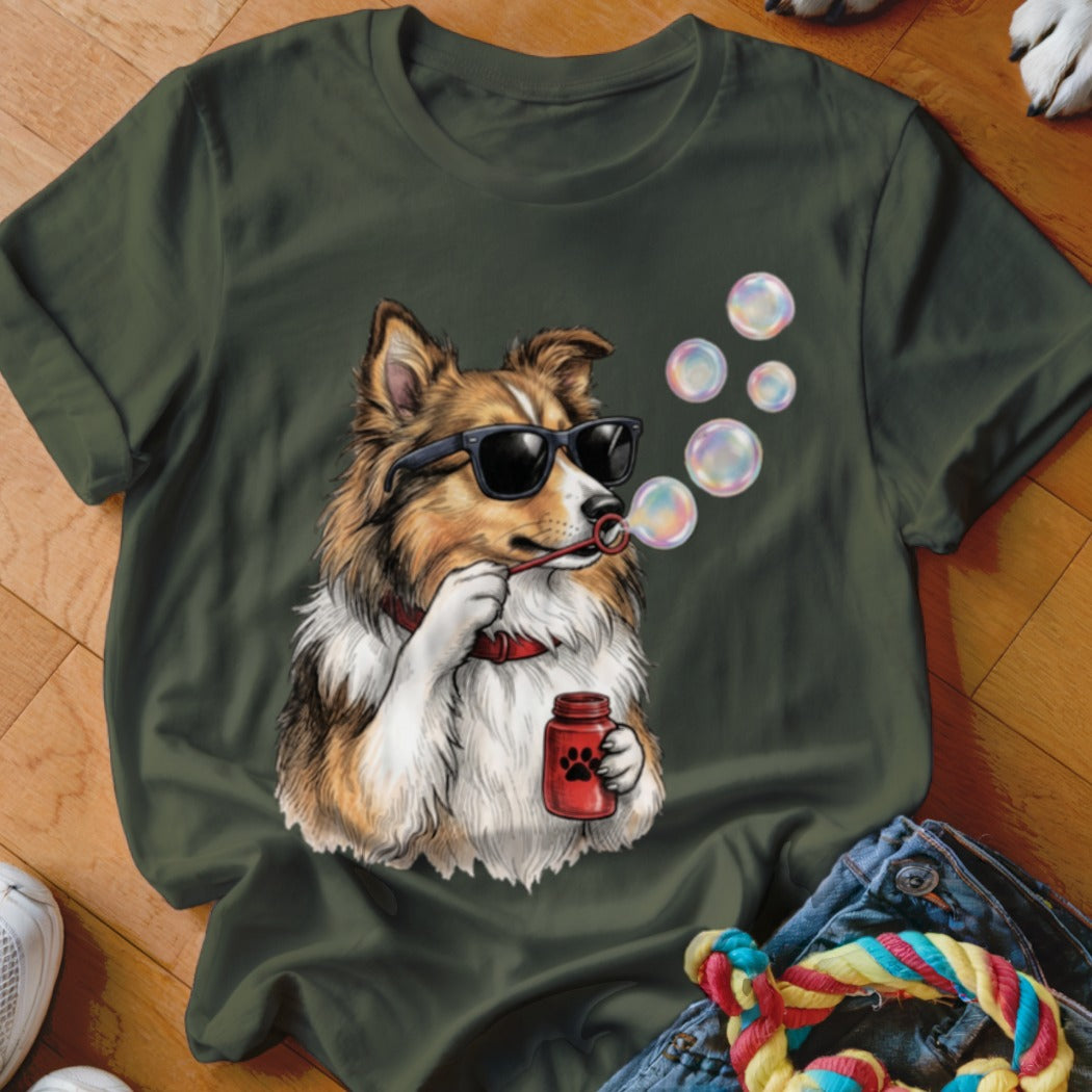 A dark green t-shirt featuring a graphic of a dog wearing sunglasses and blowing bubbles.