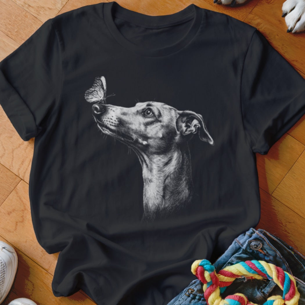 Black t-shirt featuring a monochrome graphic of a dog looking at a butterfly on its nose.