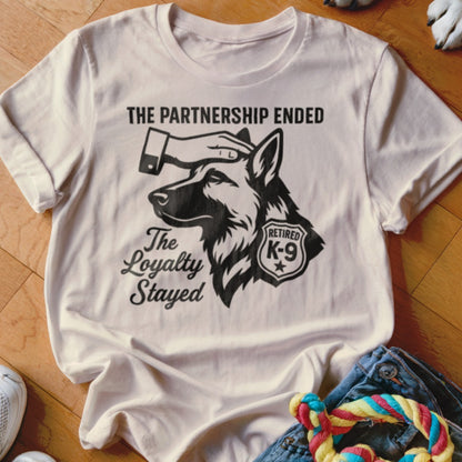 White t-shirt with graphic of German Shepherd, hand on head, and "The Partnership Ended, The Loyalty Stayed" text.