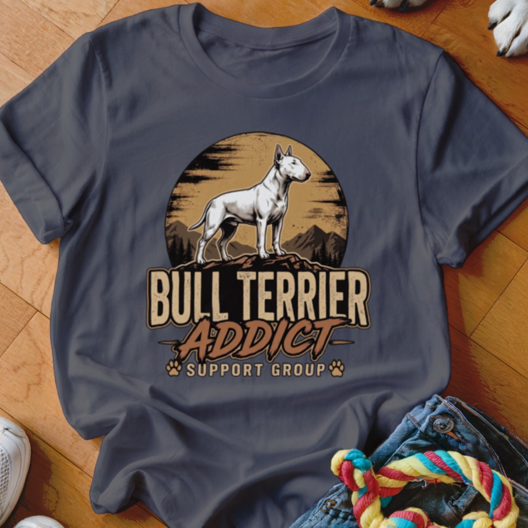 A dark gray crewneck t-shirt featuring a vintage graphic of a bull terrier standing on a mountain against a sunset, with text reading "BULL TERRIER ADDICT SUPPORT GROUP".