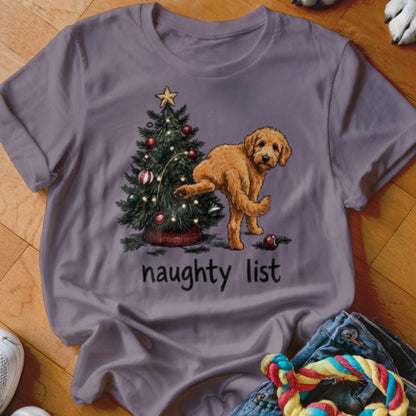 Goldendoodle next to Christmas tree with text "naughty list"