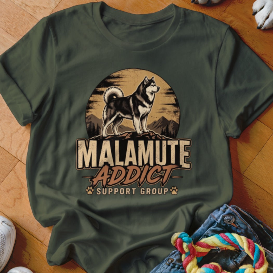 Dark green crewneck t-shirt featuring a graphic of an Alaskan Malamute, mountains, sun, and the text MALAMUTE ADDICT SUPPORT GROUP.