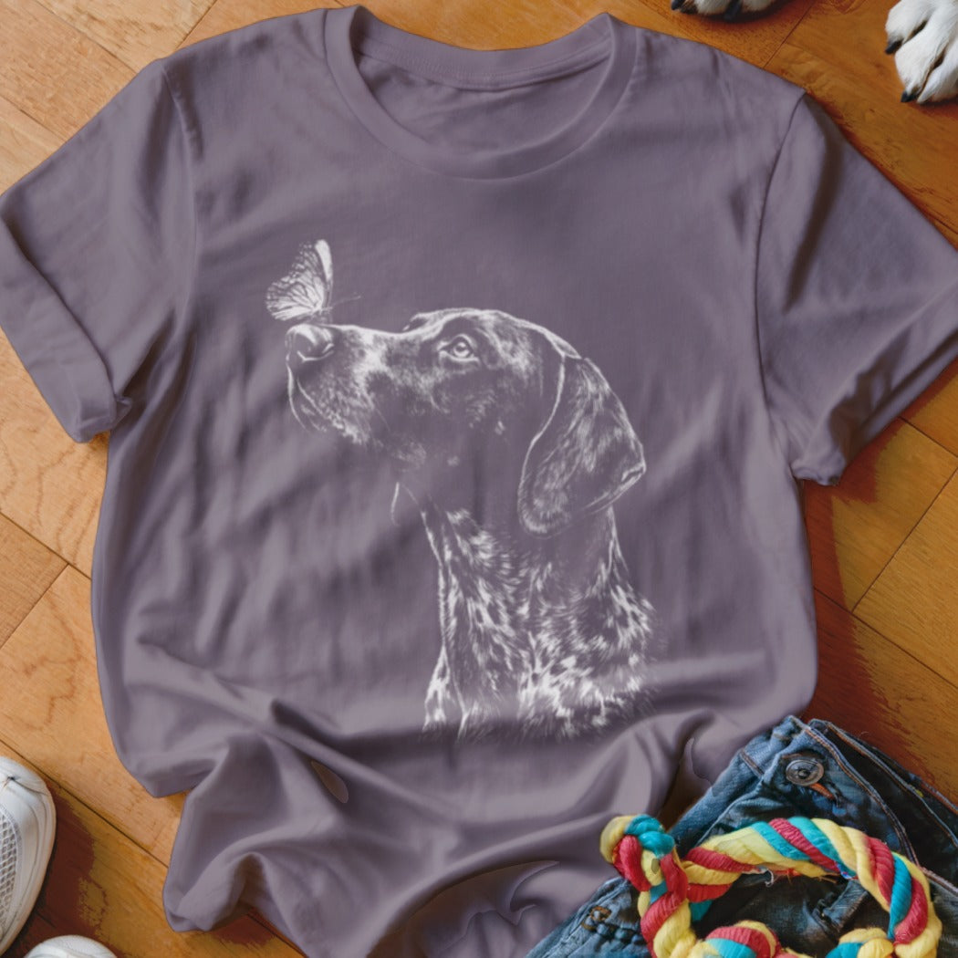 Slate grey t-shirt featuring a white graphic of a pointer dog looking at a butterfly on its nose.